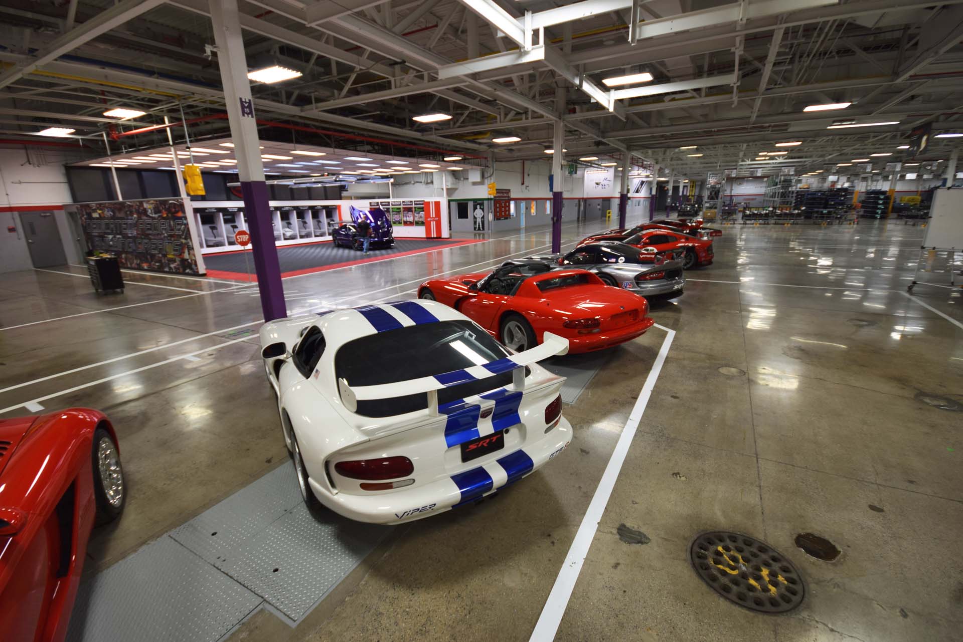 Just inside the front doors and in front of the main assembly area, a selection of retired Dodge Vipers are on perpetual display. Race-cars, concepts and production models are lined up, reminding workers of the storied history of the Viper. They also form a unique centrepiece for visiting owners and customers, reminding them of the model’s heritage. See the purple Viper in the background? That’s the customer pick-up area, where lucky owners are encouraged to take delivery of their new Viper, just across the floor from the selection of retired models.