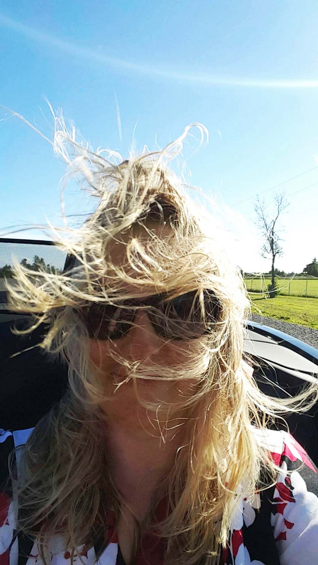 It's important to pack a hair tie for one's first trip in a convertible. 
